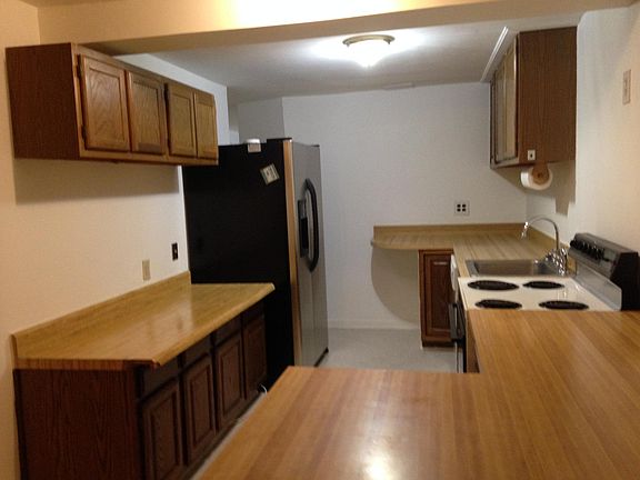 Kitchen area. Cabinets have been recently repainted white.