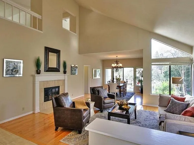 Inviting Living Room with Vaulted Ceilings and Walls of Windows Overlooking the Backyard with Amazing Views