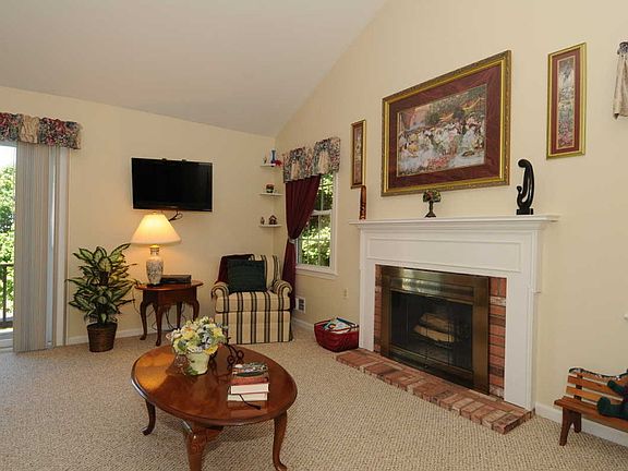 Living Room Boasts Cathedral Ceiling,  Fireplace & Sliders to Deck