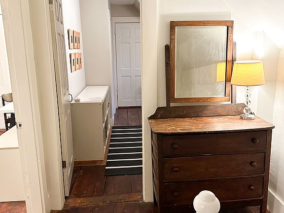 top of the stairs, looking down into the kitchen, living room on the left
