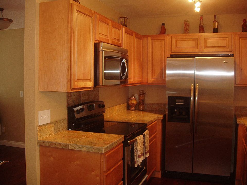 Kitchen features granite counters, stainless appliances and maple cabinets