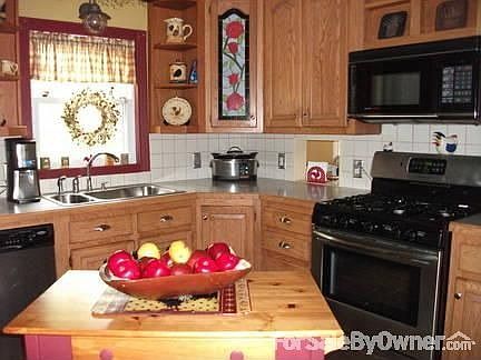 Country kitchen with ss appliances