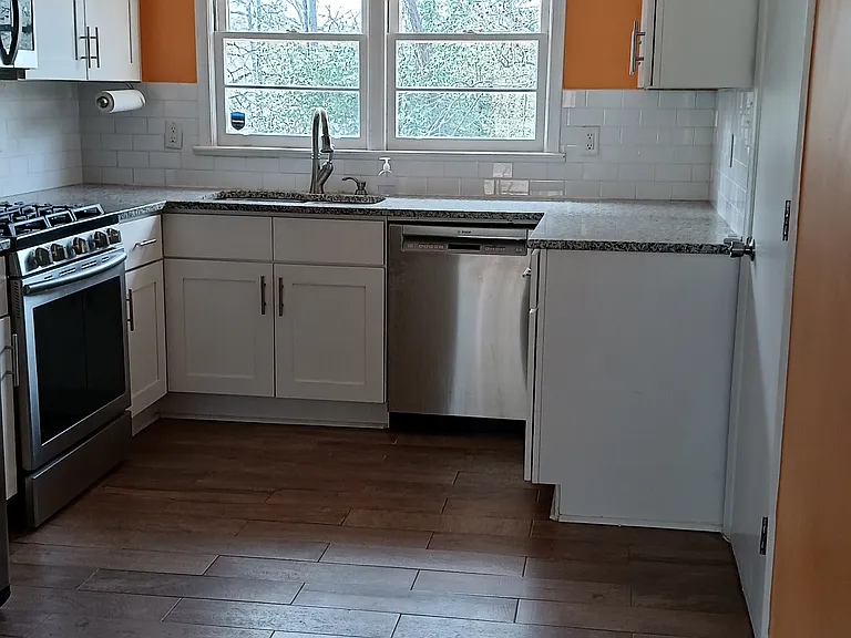 Bright kitchen faces west. There is room for an island or two-seater countertop.