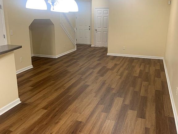 dining area across from kitchen with living room behind it