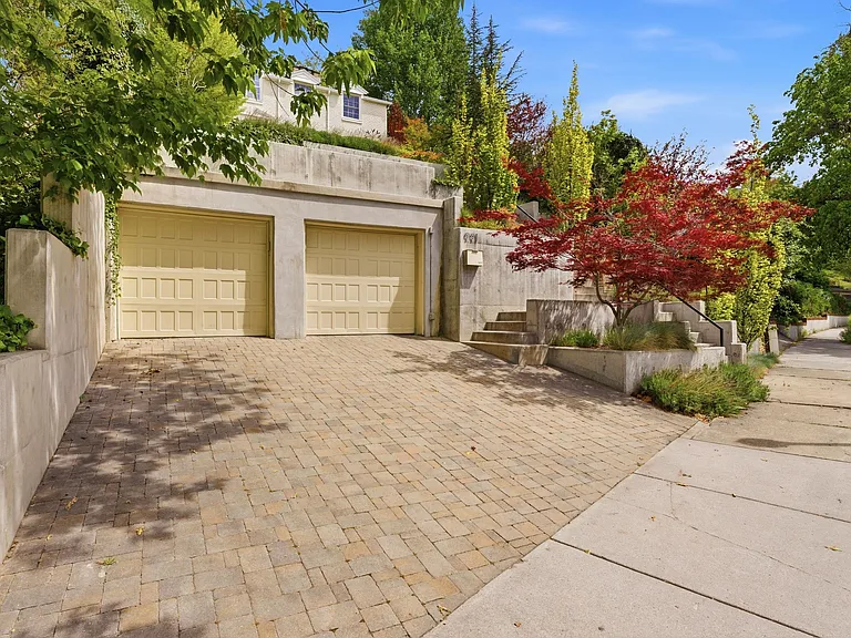 Front walkway from the street. There is also a covered private tunnel from the 2 garages directly to the lower level of the house. Additional parking for 4 cars in a huge garage accessible from the back of the house.