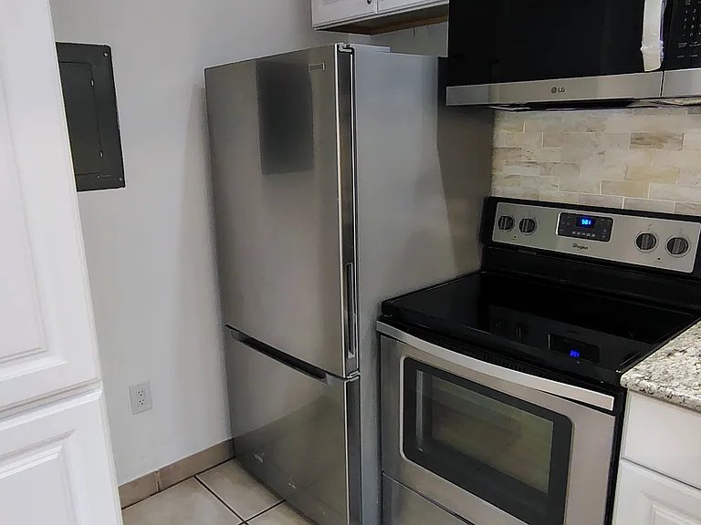 2026 fridge, microwave and polished-marble backsplash