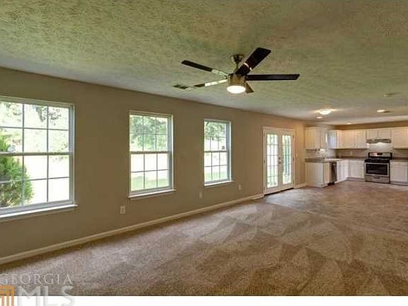 Another view of this bright and open floor plan, french doors open up in a flat patio area and a Pri