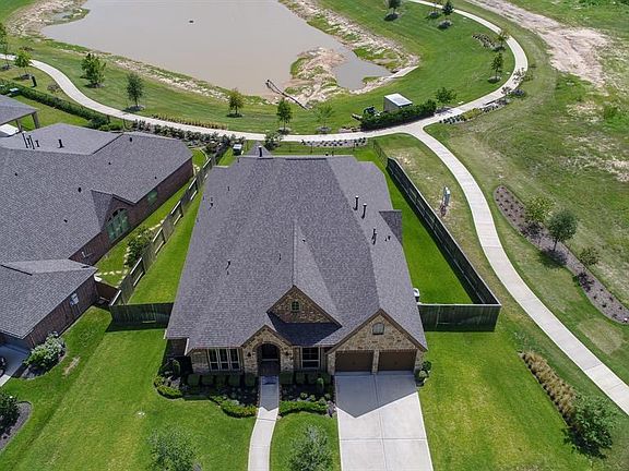 Aerial photo of this home shows all of the space around this house and the large backyard! It is situated on a lake lot and has no neighbors behind or towards the right!