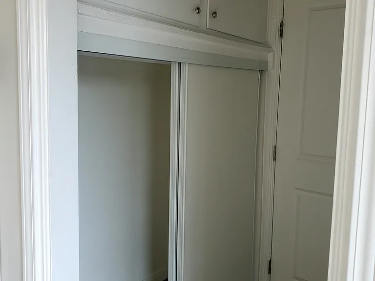 view of upper storage for hallway closet