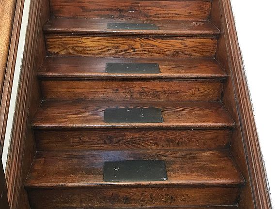 There are two sets of stairs leading up the apartment