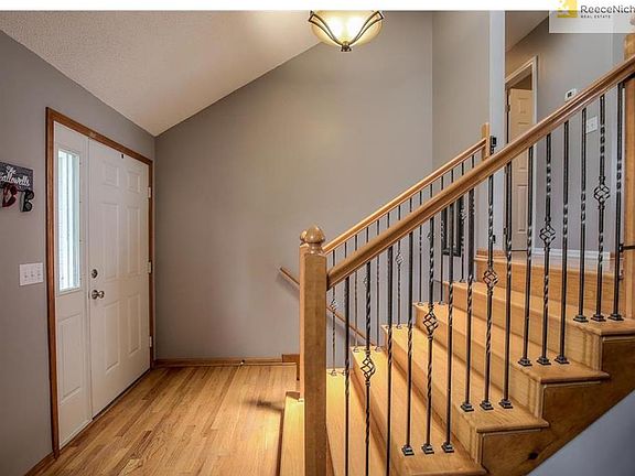 Great entry with wood floors & rot iron spindles!