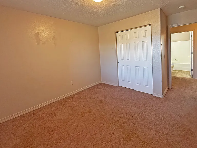3rd Bedroom with open door oevrlooking the hallway and the 2nd bath