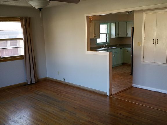 Large, open-concept living room with hardwood floors.