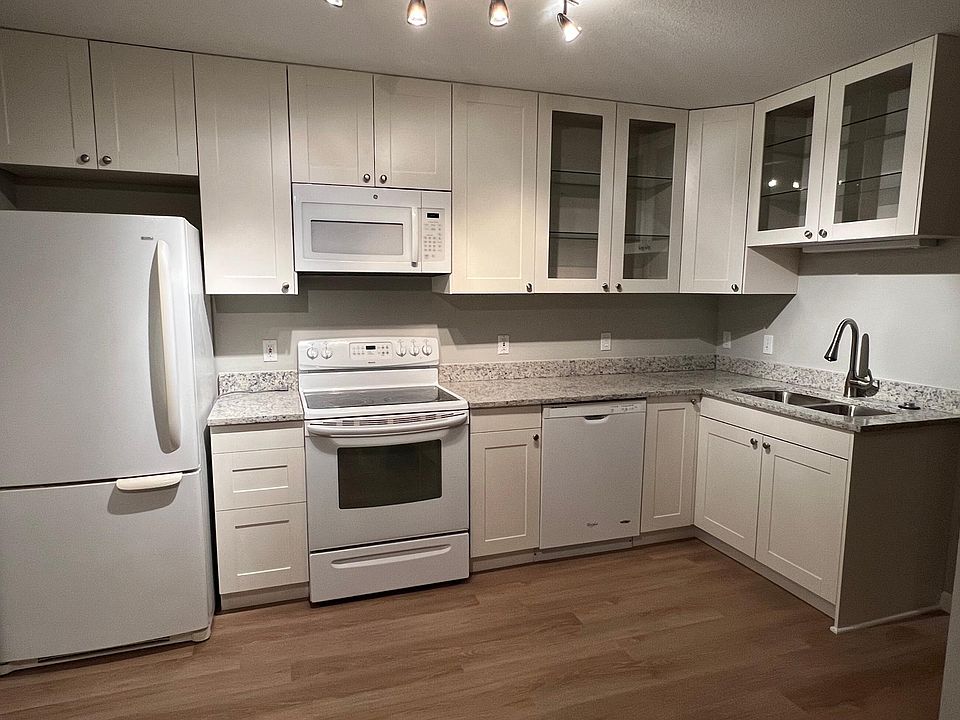 Eat-in kitchen with large cabinets for extra storage, granite counter top, pantry and sliding door to private patio.