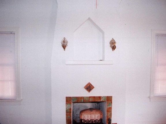 Beautiful Faux Fireplace with sconces, original tile in large living room