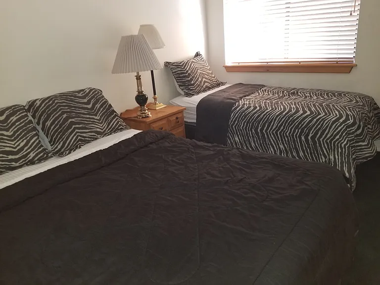 Upstairs queen bed and single with closet and small bathroom