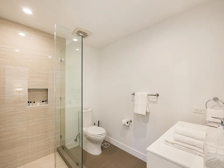 Indulge in luxury in the beautifully appointed bathroom, complete with a shower and all the essential amenities for a comfortable stay.