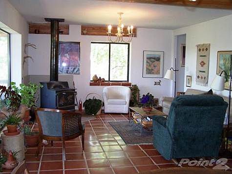 The great room has a woodburning stove and lots of windows.