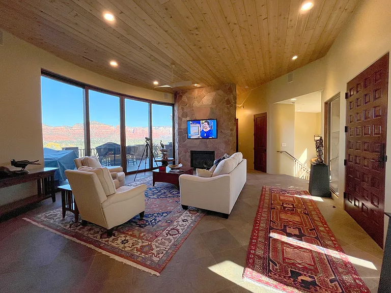 Living Room and Foyer with Stairway to Lower Level and Hall to Master Suite 2