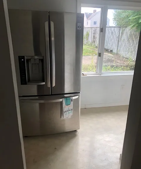 view from dinning room into large kitchen and window overlooking the back yard