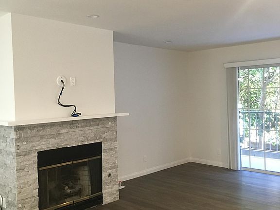 Living room with fireplace and built in TV hookups, downstairs balcony