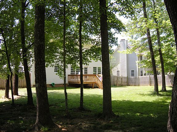 Backyard has a nice sunny area as well as trees for more natural space.