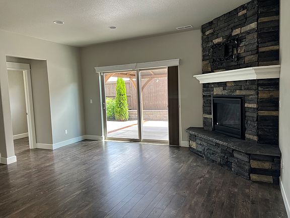 living room with gas fireplace. sliding glass door to back yard