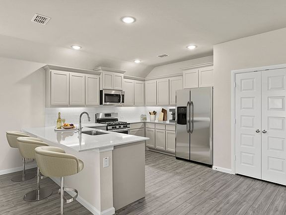 Kitchen in the Emmy II home plan by Trophy Signature Homes - REPRESENTATIVE PHOTO