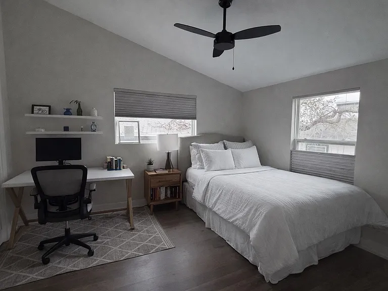 Guest bedroom with ample closet space and abundant natural light.