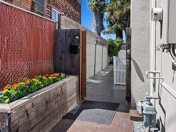 Private, gated entry leading to a fully enclosed patio with outdoor seating _ a quiet space for morning coffee or relaxing at the end of the day.