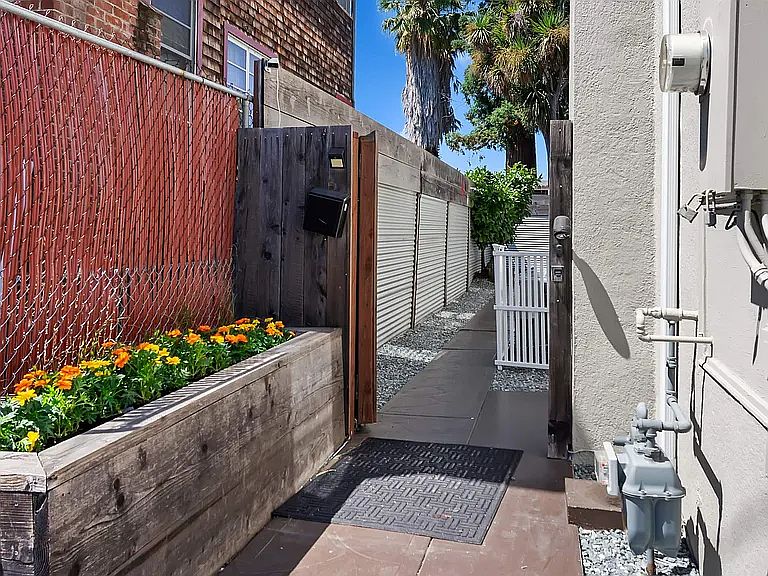 Private, gated entry leading to a fully enclosed patio with outdoor seating _ a quiet space for morning coffee or relaxing at the end of the day.