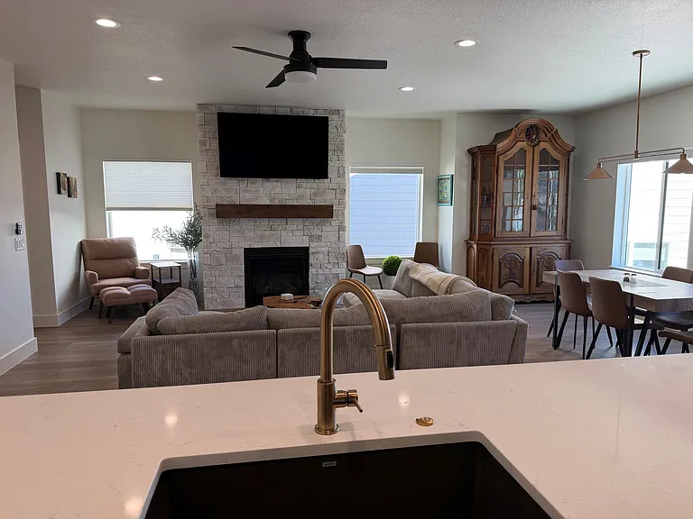 View from kitchen of living room, fireplace and TV