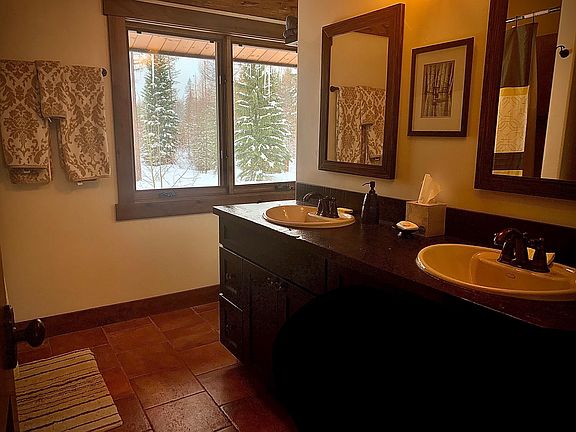 Master bathroom, with tile floors, double sinks, wood cabinetry, shower and tub