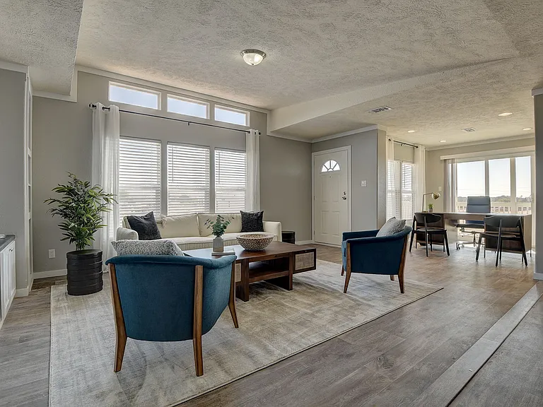 Bright, open-concept living space filled with natural light, featuring elevated ceilings, expansive windows, and seamless flow_perfect for comfortable living and stylish entertaining.