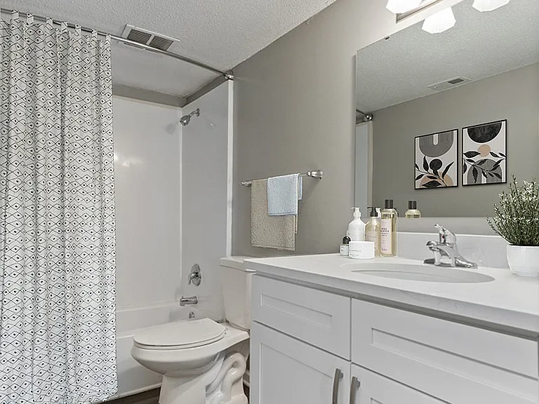 Experience the blend of style and comfort in this beautifully designed bathroom.