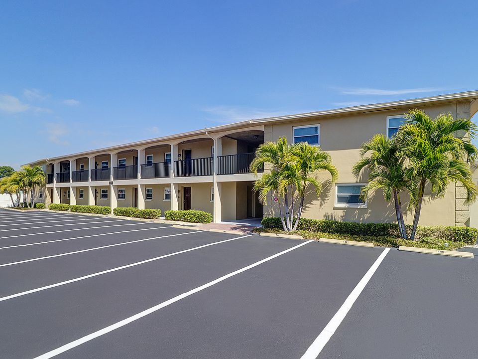 Unit 107 is the corner apartment between the palm trees in this photo