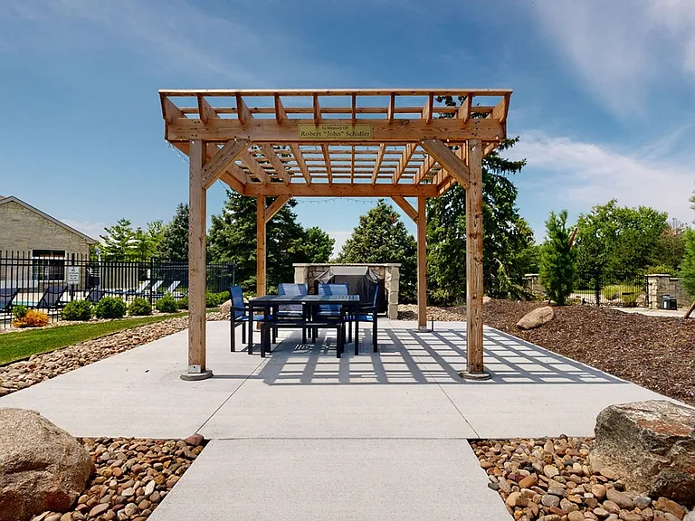 Dine or relax under the pergola in our beautifully landscaped outdoor space. Book a tour today!