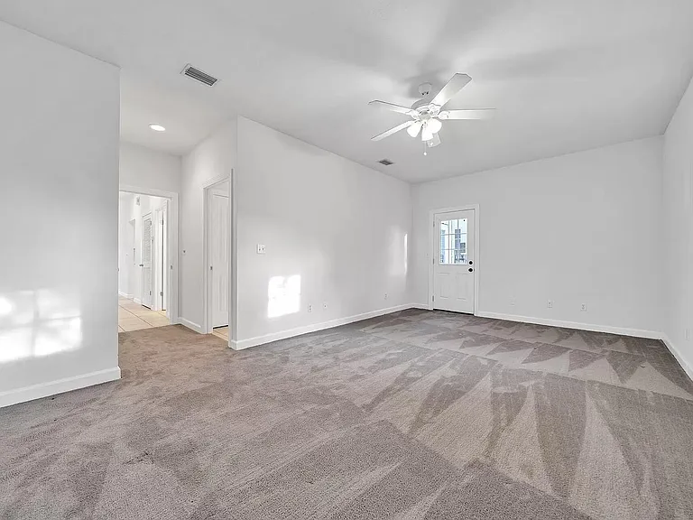 Primary bedroom, door to back patio