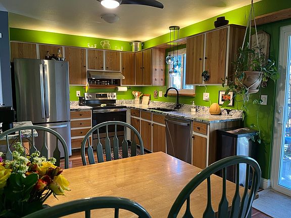 Dine-in kitchen updated in 2021 with stainless steel appliances and granite countertop. Custom oak and granite rolling coffee cart included for extra counterspace.