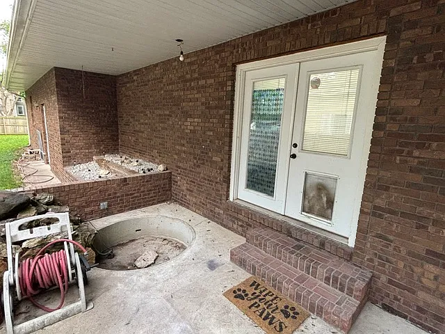 Rear doggy door and concrete back deck for grilling. Fountain is currently non-functional.