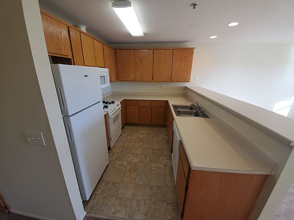 Full kitchen with refrigerator, microwave, stove, dishwasher, and garbage disposal. The stove and oven are gas. Plenty of counter and cabinet space.