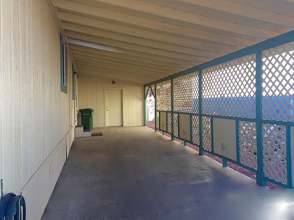 long convenient carport with storeroom at rear