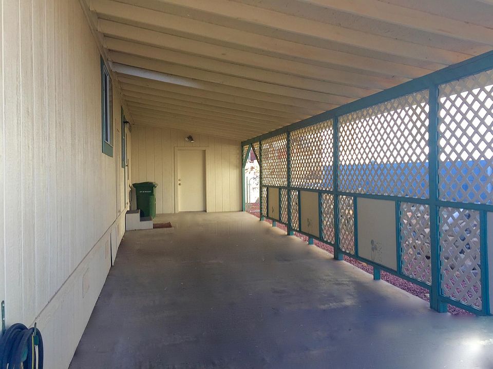 long convenient carport with storeroom at rear