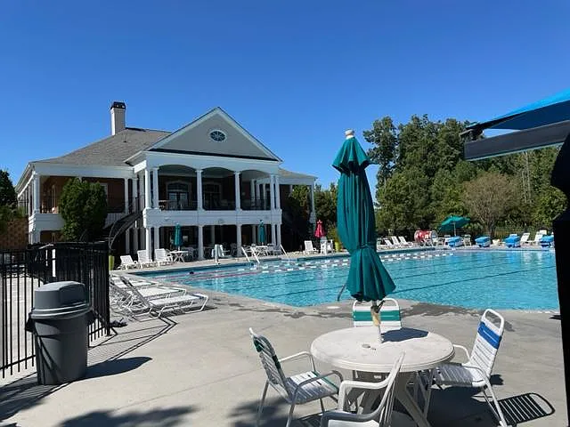 Main Swimming pool showing clubhouse. There is a smaller kiddie pool on the side