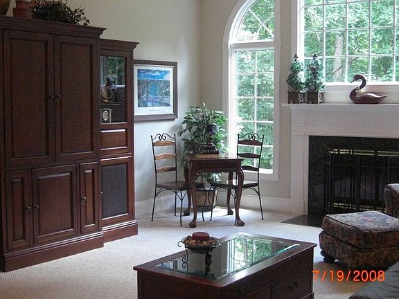 Family room with gas fireplace, large windows and vaulted ceiling