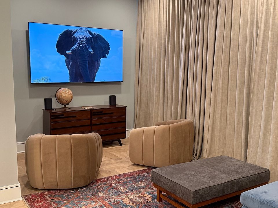 85" TV with blackout curtains for theater-like movies or business presentations