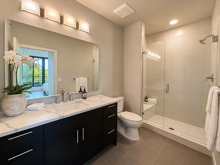 Primary en-suite bath with glass surround shower.