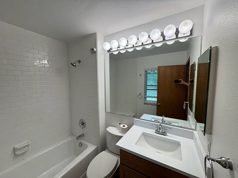 Master Bath with oversized 66" cast iron Toto tub. Toto lavatory and new quartz vanity top and new faucet. Hollywood lights on dimmer