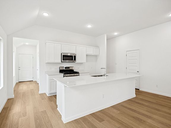 Kitchen in the Spruce home plan by Trophy Signature Homes - REPRESENTATIVE PHOTO
