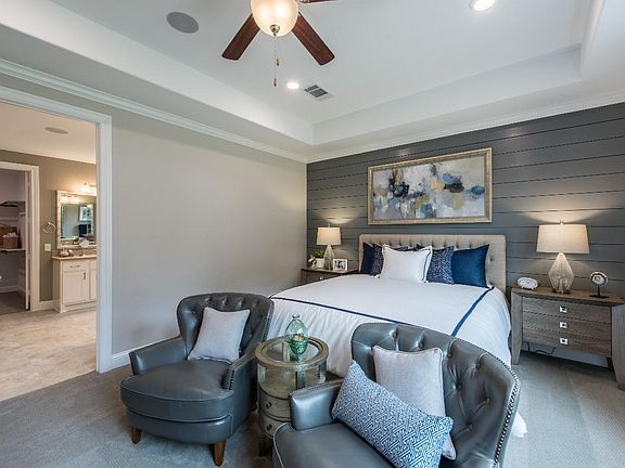 Spacious primary bedroom suite with tray ceiling